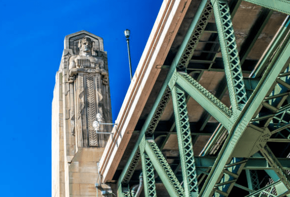 A tall tower with a statue on top of it.